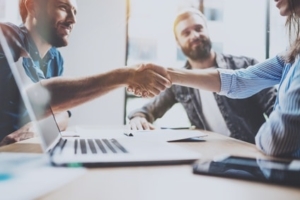 Business partnership handshake concept.Photo two coworkers handshaking process.Successful deal after great meeting.Horizontal, blurred background.