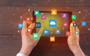 Hand using multitask tablet with application symbols and icons concept